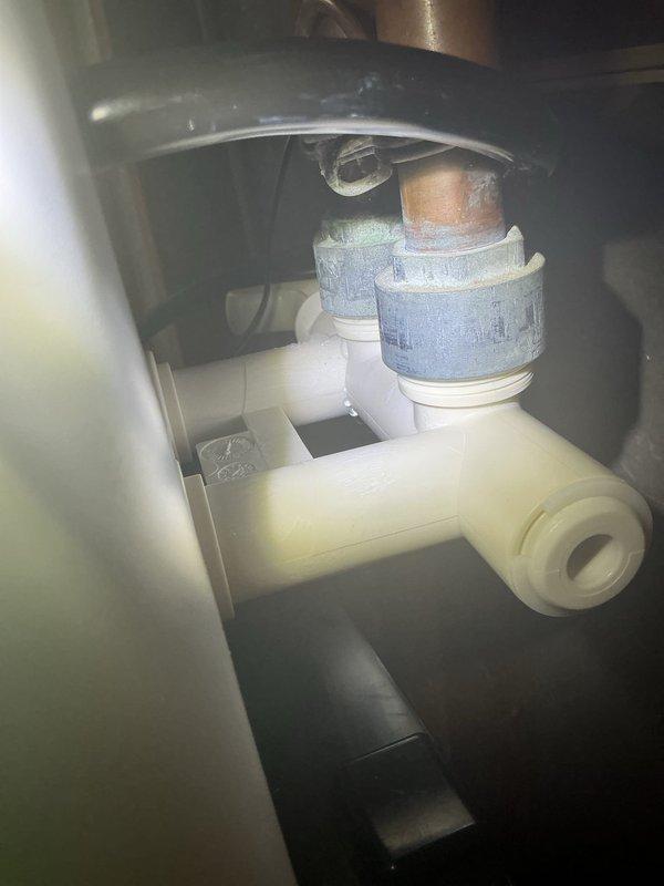 Responded to service call for a leaking water softener. Upon inspection, identified a failing bypass valve gasket causing the drip. Documented the damage with photos of the installation space and plumbing connections. Recommended complete replacement of the water softener as the most effective solution for the aging system.