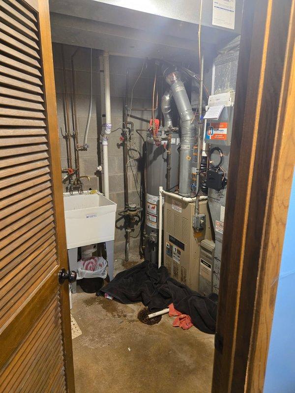 Responded to service call for a leaking water heater. Diagnosed that the relief valve was discharging due to an overheating gas valve. Discussed repair versus replacement options with homeowner. Inspected Rheem Classic water heater installation and surrounding utility area for additional issues.