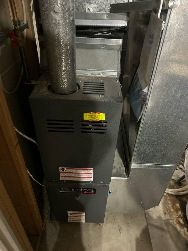 Performed complete preventative maintenance on 20-year-old Goodman furnace at end of expected service life. System operating safely with proper gas pressure, good electrical connections, and clean filter. Maintenance included cleaning flame sensor, verifying ignitor operation, and checking amp draws on inducer and blower motors. Condensation drains clear; noted some rusting but heat exchanger appears intact. Observed significant water discharge from adjacent water heater.