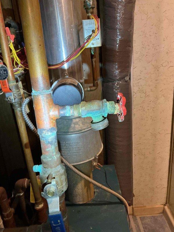 Responded to service call for 24-year-old Burnham boiler with temperature control issues in one of three zones. Diagnosed and replaced seized power head on zone valve that was stuck in open position, causing zone to overheat (85°+) regardless of thermostat setting. Noted two additional aging power heads requiring replacement, leaking gate valves at drains, leaking pressure relief valve, and 1ppm CO leak at lower left boiler jacket seal. Client enrolled in rewards program.
