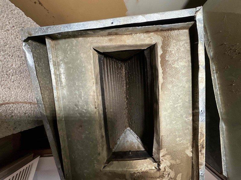 Completed installation of a 70K BTU 80% efficient furnace with chimney liner. Installed condensate drain pan for future coil addition. Ductwork inspection revealed significant dust accumulation in the existing system, which was documented with photos.