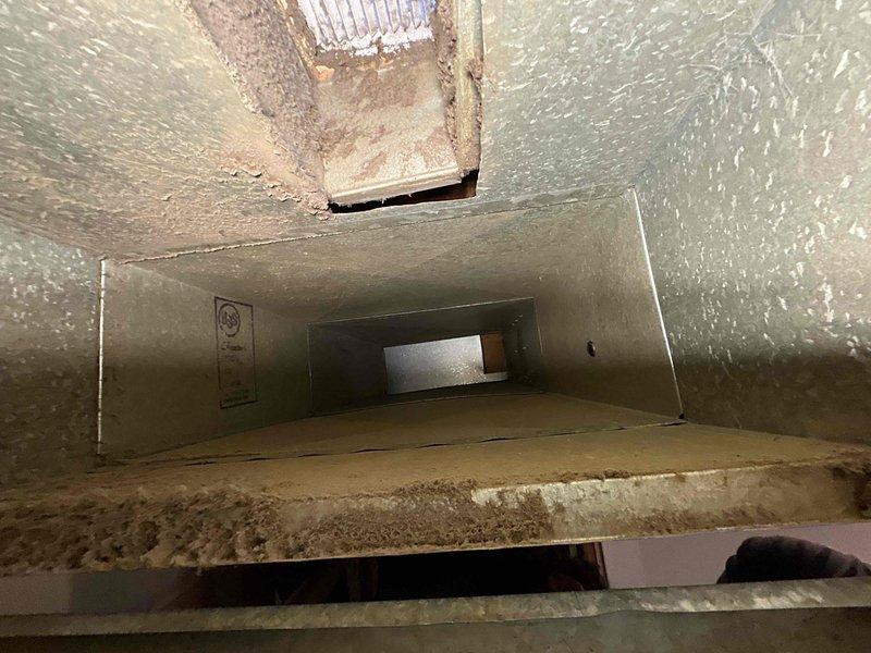 Completed installation of a 70K BTU 80% efficient furnace with chimney liner. Installed condensate drain pan for future coil addition. Ductwork inspection revealed significant dust accumulation in the existing system, which was documented with photos.