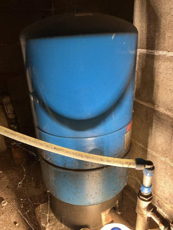 Resolved fluctuating water pressure issue by replacing faulty pressure tank. System inspection revealed pressure switch was operating properly but tank had failed. Additionally, capped off unused PVC waterlines and an abandoned cast iron pipe from previous toilet installation per customer's request.