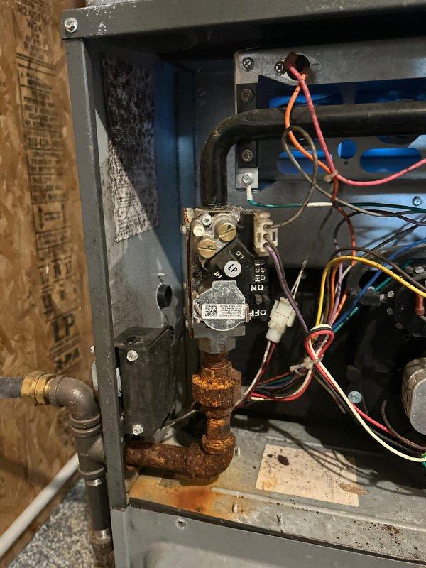Performed annual maintenance on 7-year-old Daikin furnace. Cleaned flame sensor, verified ignitor operation, and confirmed proper gas pressure settings. System is operating safely with good electrical connections and amp draws on blower and inducer, though moisture was noted inside unit. Filter was already replaced by homeowner prior to service.