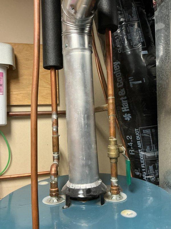 Completed return visit to finish plumbing repair service as scheduled. Replaced severely corroded pressure regulator valve that showed significant mineral deposits and blue-green oxidation. Installed new copper pipes with brass fittings to connect to existing water heating system, ensuring proper venting and connection to the main exhaust pipe.