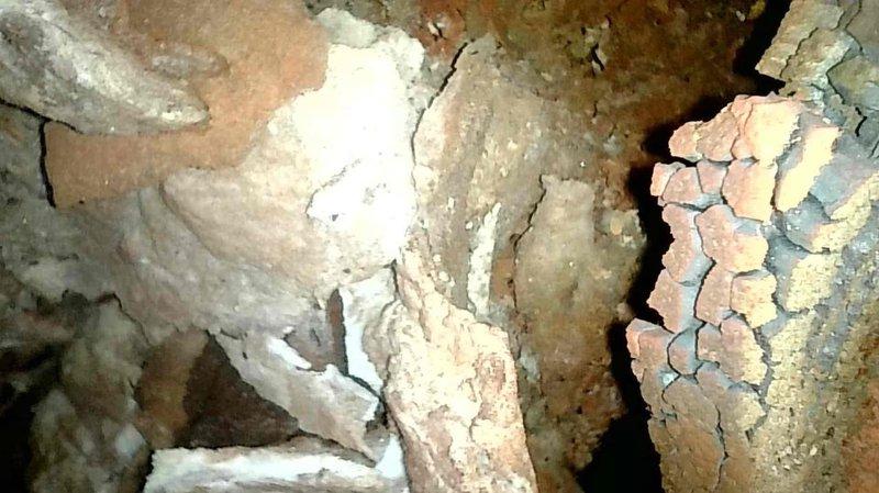Responded to no-heat call for 1977-era furnace that failed to restart after initial operation. Diagnosed primary limit switch trip and reset to restore temporary functionality. Visual inspection with camera revealed severely deteriorated refractory pot sitting crooked inside furnace, with significant cracking and fragmentation especially on the right side. Due to extensive deterioration and age of system (45+ years), repairs not feasible. Customer currently using alternative wood heating source and understood replacement recommendation.