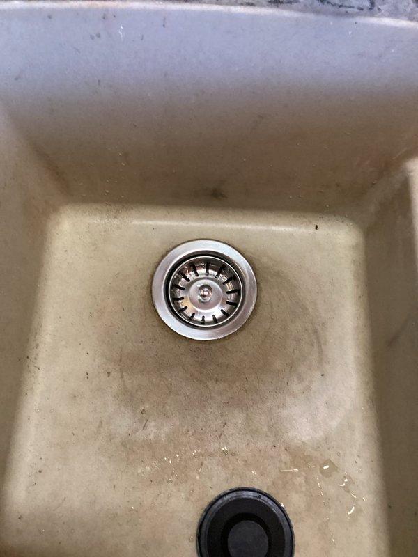 Responded to warranty service call for previously installed trap system where sink was clogged and garbage disposal was leaking. Successfully snaked drain to clear blockage and removed faulty garbage disposal unit, restoring proper drainage function to the kitchen sink.