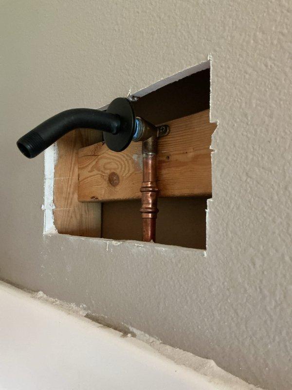 Replaced broken shower arm after removing threaded portion that was stuck in the wall. Removed access panel to replace damaged 90-degree copper fitting, then installed new winged 90 and reattached shower arm to restore functionality. Replaced broken shower arm after removing threaded portion that was stuck in the wall. Removed access panel to replace damaged 90-degree copper fitting, then installed new winged 90 and reattached shower arm to restore functionality.