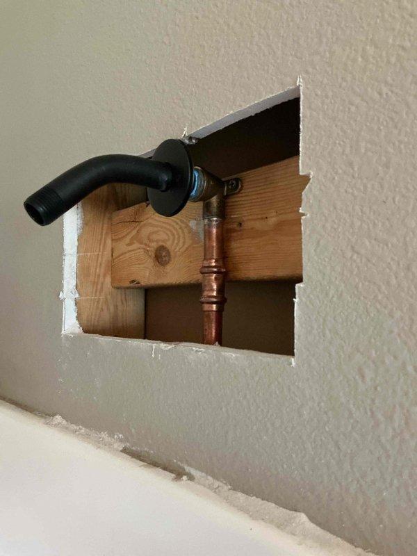 Replaced broken shower arm after removing threaded portion that was stuck in the wall. Removed access panel to replace damaged 90-degree copper fitting, then installed new winged 90 and reattached shower arm to restore functionality. Replaced broken shower arm after removing threaded portion that was stuck in the wall. Removed access panel to replace damaged 90-degree copper fitting, then installed new winged 90 and reattached shower arm to restore functionality.