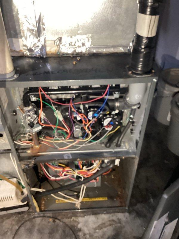 Responded to no heat complaint on 1-2 year old furnace. Diagnosed condensate backup causing pressure switch to disengage and prevent ignition. Cleaned condensate line to restore proper drainage. Identified exhaust pipe leaking at connection point sealed with improper black tape. Provided repair options for exhaust pipe to homeowner. System operational after service.