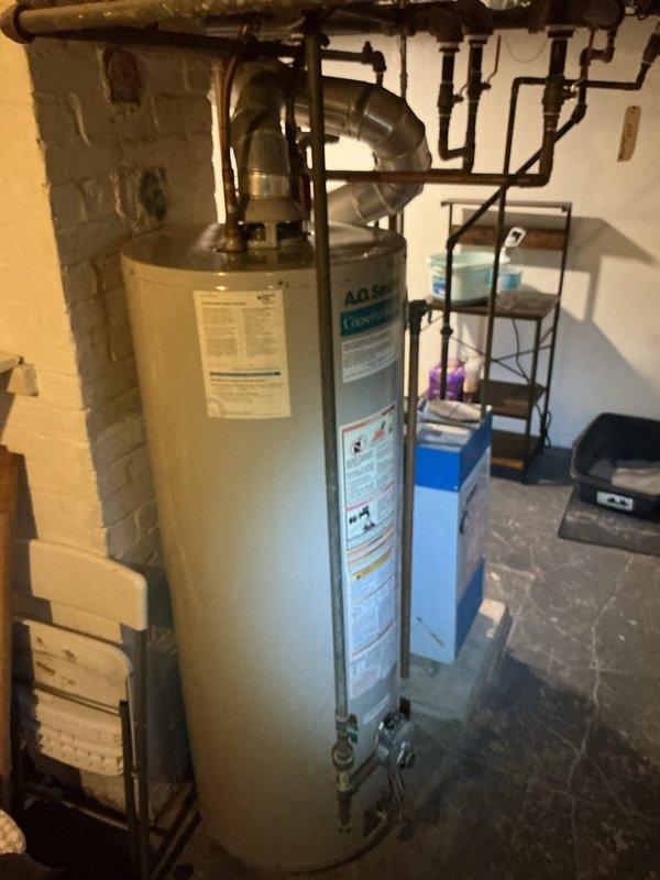 Conducted diagnostic assessment on 17-year-old water heater producing only lukewarm water. Visual inspection revealed significant age deterioration and probable heating element failure. Provided customer with replacement options including necessary minor repipe work.