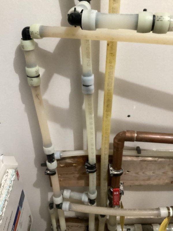 Responded to low water pressure issue affecting utility room, washer supply, and water softener. Diagnosed blockage in cold water supply lines embedded in slab. Used air compressor to clear debris by pushing back through angle stop with line cut off in mechanical room. Advised customer that complete resolution may require additional service with two technicians and specialized equipment to thoroughly blow out and trace all affected lines.