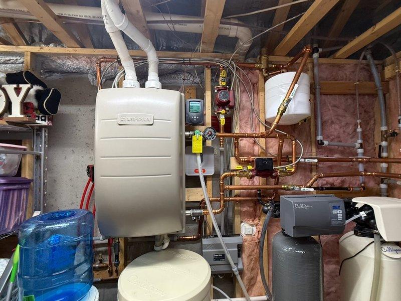 Performed annual maintenance on Carrier furnace (15 years) and American Standard boiler (4 years). Furnace maintenance included combustion testing, gas pressure verification, temperature rise check, blower removal with secondary heat exchanger inspection, and drain clearing. Boiler service revealed outdoor sensor error code caused by disconnected wire following recent siding installation; reconnected wire and resolved code. Noted deteriorating igniter gasket on boiler; system continues to function properly. Both heating zones and indirect hot water tank verified operational. Cleaned condensate trap and confirmed all systems operating correctly.
