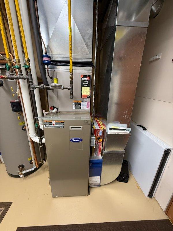 Performed annual maintenance on Carrier furnace (15 years) and American Standard boiler (4 years). Furnace maintenance included combustion testing, gas pressure verification, temperature rise check, blower removal with secondary heat exchanger inspection, and drain clearing. Boiler service revealed outdoor sensor error code caused by disconnected wire following recent siding installation; reconnected wire and resolved code. Noted deteriorating igniter gasket on boiler; system continues to function properly. Both heating zones and indirect hot water tank verified operational. Cleaned condensate trap and confirmed all systems operating correctly.
