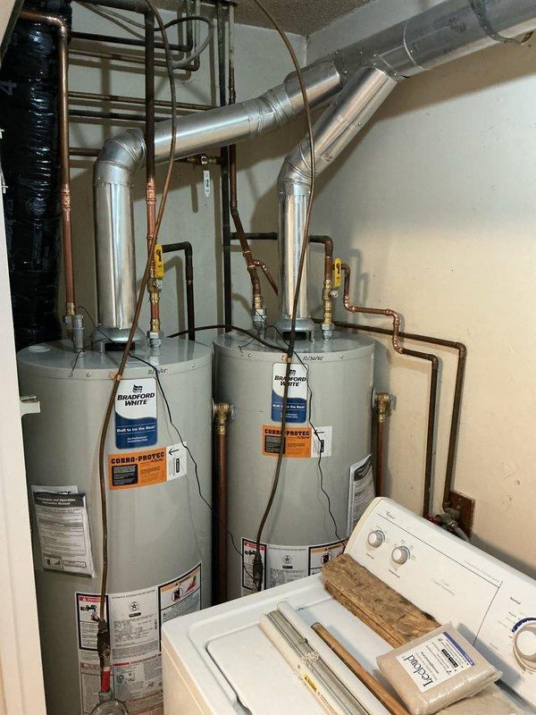 Completed installation of two Bradford White 40-gallon tall atmospheric natural gas water heaters and two cabinet-style water softeners with inline carbon filters. Installed complete connection assembly including press dielectric unions, press ball valves, gas regulators, and new electric anode rods. All units were properly mounted and secured with threaded rod support system, and a Tru Gap air gap was installed per code requirements.