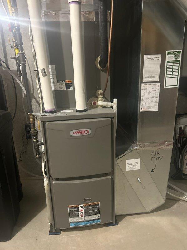 Performed scheduled 5-year tune-up on Lennox residential HVAC system. Inspected furnace and air handler components, conducted electrical diagnostics using multimeter (reading 56.5V), and verified proper airflow direction. Noted filter was in marginal condition and replaced it to ensure optimal system performance.