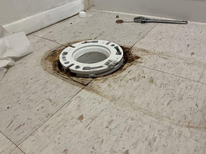 Completed replacement of deteriorated 15-year-old toilet in main floor bathroom following customer's repiping project. Removed damaged toilet and installed new Gerber Viper ADA-compliant elongated toilet with new wax ring and bolts. New fixture provides improved functionality with water-efficient operation, chemical resistance, and sanitary design features to prevent liquid intrusion under the tank.