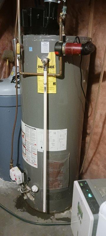 Inspected 12-year-old natural gas power vent water heater that was failing to maintain ignition. Upon examination, confirmed customer's report of a tank leak originating from the upper tank area with dampened insulation. Provided customer with replacement options.
