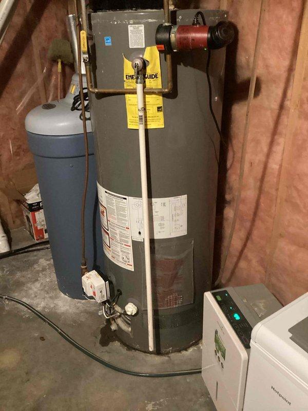 Inspected 12-year-old natural gas power vent water heater that was failing to maintain ignition. Upon examination, confirmed customer's report of a tank leak originating from the upper tank area with dampened insulation. Provided customer with replacement options.