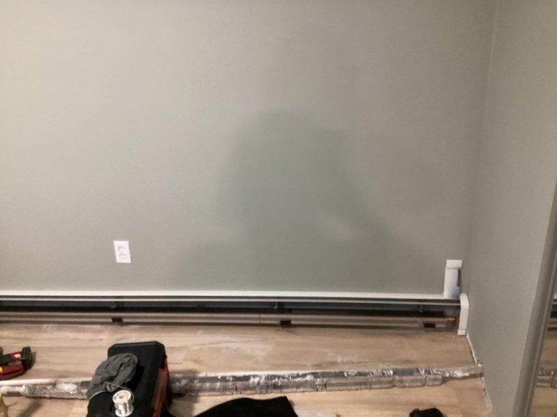 Completed installation of new hydronic baseboard heat on the lower level, including fin tube baseboard units in the living room and bedroom. Connected lines back to the lower level boiler zone, flushed the system, and filled with water and glycol antifreeze. Added a shut off and drain to the boiler for water fill, purged air from all zones, and set pressure to 19 psi, returning system to normal operation.