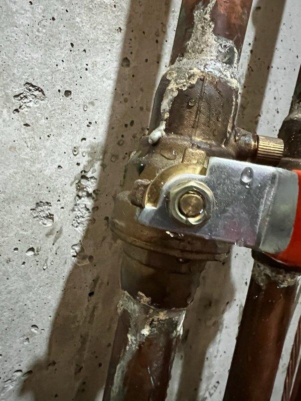 Inspected outdoor spigot shut-off valve system in basement and determined the existing valve does not fully close, allowing water to continue flowing even when in "off" position. Identified significant corrosion and mineral deposits at copper pipe joints and connection points. Customer advised of options for replacing the aging KITZ 600-150S valves, but elected to consider replacement at a later date and will temporarily manage by shutting off the exterior spigot at the house.