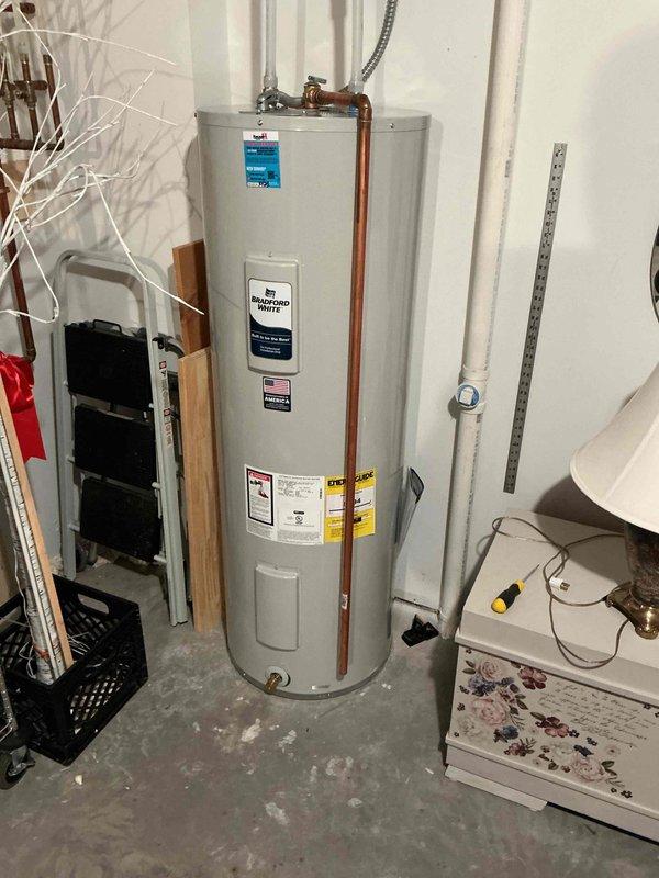 Responded to emergency no hot water call for a 10-year-old electric water heater that was only producing lukewarm water and unable to reach proper temperature. Upon inspection, discovered green mold growth on the unit. Replaced the failing water heater with a new 50-gallon electric model, ensuring proper plumbing connections and electrical hookup per code requirements.