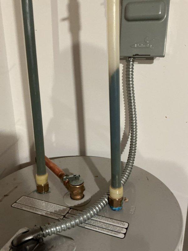 Responded to emergency no hot water call for a 10-year-old electric water heater that was only producing lukewarm water and unable to reach proper temperature. Upon inspection, discovered green mold growth on the unit. Replaced the failing water heater with a new 50-gallon electric model, ensuring proper plumbing connections and electrical hookup per code requirements.