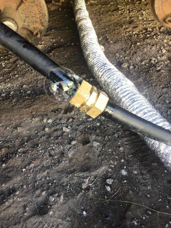 Responded to no heat call due to gas leak. Located significant leak at gas-tite line connection underneath home. Replaced defective fitting and tightened lock washer and connection to proper specifications. Pressure tested repair with bubble solution confirming leak cessation, then restored gas service and reinstalled skirting panel.