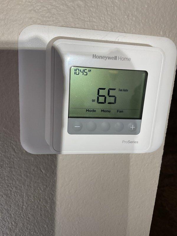 Responded to no-heat call for a furnace with pilot light ignition but non-functioning main burners. Diagnosed low continuity in flame sensor and performed cleaning with Scotch-Brite. While cleaning provided temporary improvement, advised customer about age and condition of furnace, noting this was a temporary solution. System uses Honeywell ProSeries thermostat and Smart Valve 6-1 control.