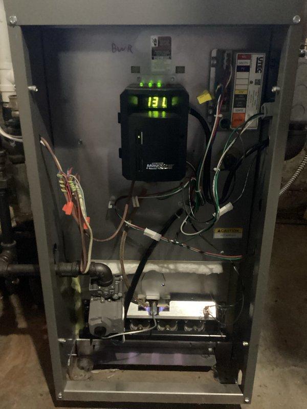 Completed scheduled bi-annual Family Rewards maintenance on 2-year-old boiler system. Performed comprehensive furnace tune-up with inspection of internal components including control board (displaying code 1311) and heat exchanger assembly. System is operating correctly with no issues identified or repairs required.