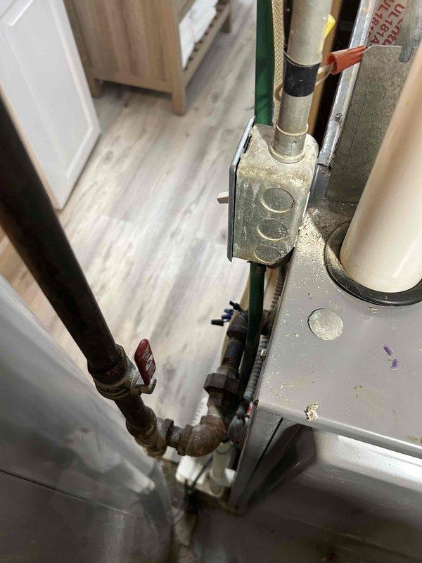 Performed comprehensive furnace tune-up safety inspection for daycare conversion. Discovered detached exhaust PVC connection that was improperly sealed; repaired with proper priming and gluing. Service included carbon monoxide testing, heat exchanger inspection, gas pressure adjustment, flame sensor cleaning, deep vacuum with removal of spider/debris buildup, condensation trap cleaning, and verification of condensation pump functionality. Noted incorrect filter installation and advised homeowner.