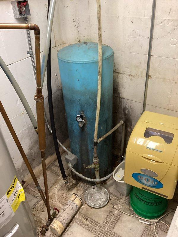 Diagnosed non-functioning water system with pressure switch calling for water but inoperable pump. Inspected aging pressure tank (approximately 80 years old) and discovered significant deterioration in the plumbing infrastructure including damaged insulation and worn components. Customer also experiencing issues with electric in-floor heat boiler; provided professional referrals for well pump replacement and HVAC service.
