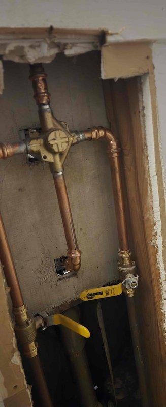 Completed installation of a Moen T2133/2520 chrome shower valve system, replacing the existing fixture. Accessed plumbing through wall, connected new valve assembly to existing copper supply lines, and installed matching tub spout and shower head. Work included proper mounting of all components and verification of operation before completion.