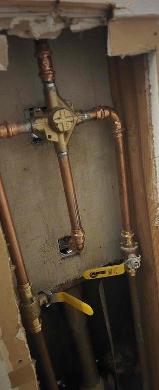 Completed installation of a Moen T2133/2520 chrome shower valve system, replacing the existing fixture. Accessed plumbing through wall, connected new valve assembly to existing copper supply lines, and installed matching tub spout and shower head. Work included proper mounting of all components and verification of operation before completion.