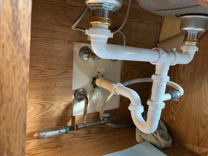 Responded to service call for kitchen sink with leaking strainers. Upon inspection, discovered deteriorated drain components with significant debris accumulation in upper third of pipes. Replaced both kitchen sink strainers, installed new continuous waste assembly, and fitted new P-trap to resolve leakage issues and restore proper drainage function.