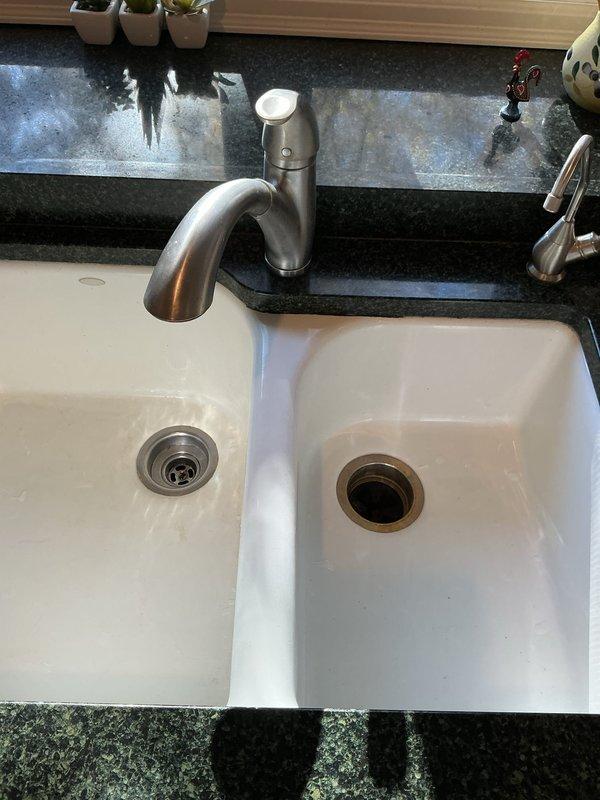 Installed new 1/2 HP garbage disposal with 5-year warranty in customer's kitchen sink, replacing existing unit while utilizing existing connections. The new disposal features removable splash guard, permanently lubricated sleeve bearings, cast stainless steel impellers, stainless steel grind ring, balanced turntable, balanced armature shaft, and factory-installed power cord.