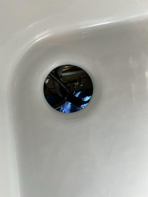 Installed new 1/2 HP garbage disposal with 5-year warranty in customer's kitchen sink, replacing existing unit while utilizing existing connections. The new disposal features removable splash guard, permanently lubricated sleeve bearings, cast stainless steel impellers, stainless steel grind ring, balanced turntable, balanced armature shaft, and factory-installed power cord.