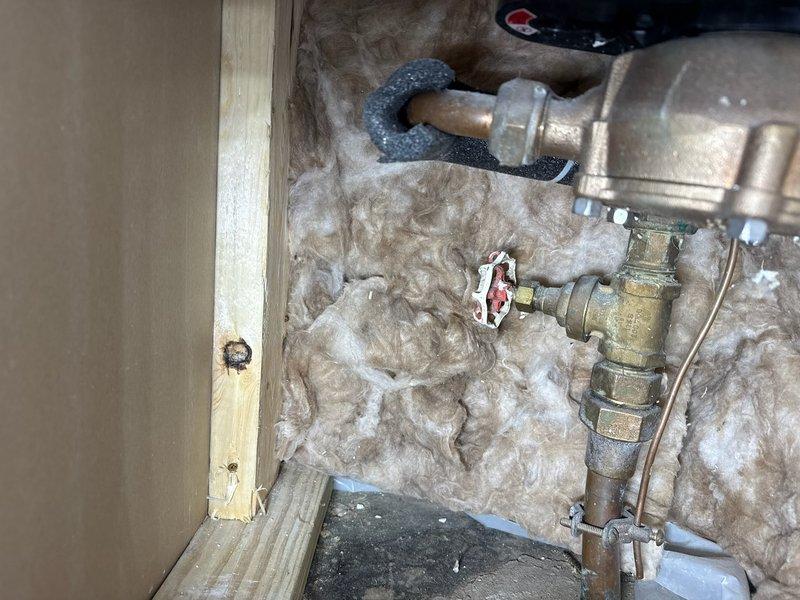 Replaced non-operational main shut-off valve after water was shut off to the house. Installed new brass valve assembly with proper connections within the insulated wall cavity, ensuring system integrity. Verified functionality of the replacement valve before completing the job.