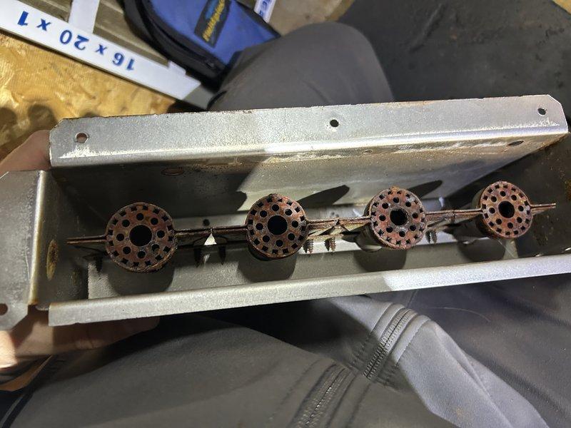 Replaced four-burner assembly in gas furnace due to oxidized and deteriorated condition of original components. Removed existing burner assembly, installed new burner units, and verified proper ignition and flame operation. System now functioning within normal parameters.