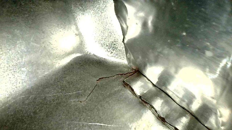 Performed maintenance inspection on a 15-year-old Trane furnace. Identified and documented a compromised heat exchanger, evidenced by significant cracking in the metal surface. Scheduled same-day estimate for replacement options.