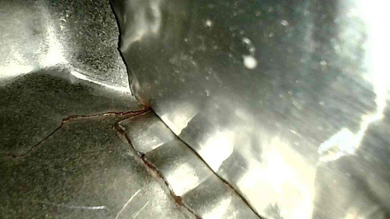 Performed maintenance inspection on a 15-year-old Trane furnace. Identified and documented a compromised heat exchanger, evidenced by significant cracking in the metal surface. Scheduled same-day estimate for replacement options.