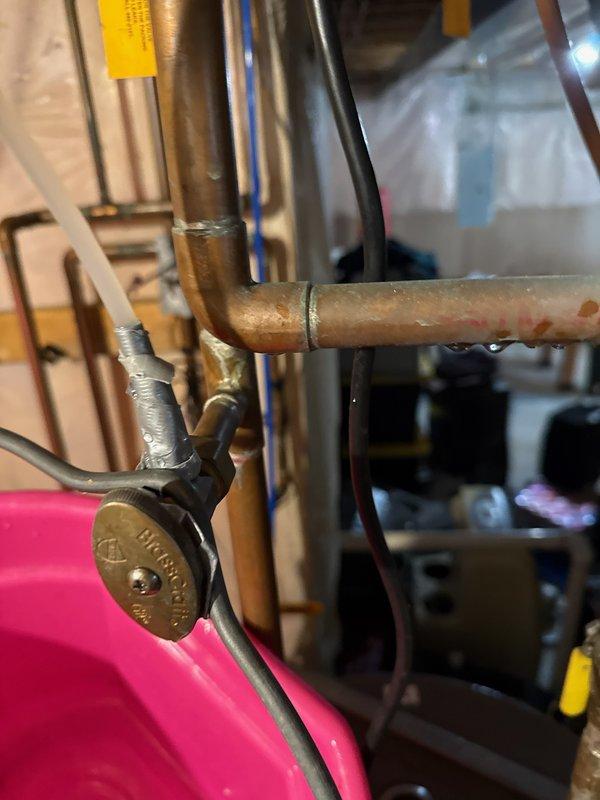 Diagnosed water leak from humidifier shut off assembly caused by damaged compression fitting, adapter, and a stuck open valve. Cut out damaged section of tubing, installed new adapter and compression fitting to stop the leak. Verified proper furnace operation and confirmed humidifier is now functioning correctly.