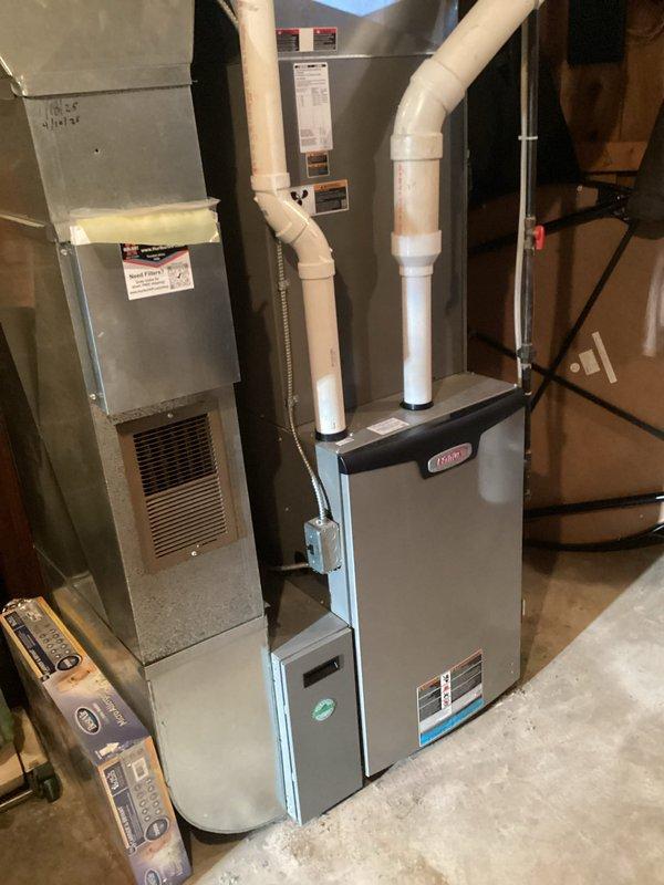 Performed comprehensive tune-up on 4-year-old Lennox furnace responding to customer's concerns about excessive noise and inconsistent heating. Found and replaced severely clogged air filter, identified burnt-out UV bulb, and discovered corrosion developing on burner assembly. All electrical components tested within specifications, condensate lines were cleared, and heat exchanger inspection showed no compromises. System operated properly during 15-minute test run with appropriate temperature rise of 80 degrees. Customer was educated about normal two-stage operation and provided estimate for recommended burner cleaning and UV bulb replacement.