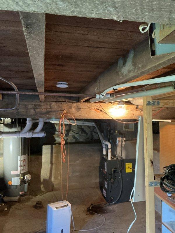 Found water softener draining improperly into non-connected ground pipe. Redirected discharge into nearby existing standpipe to establish proper drainage connection to sanitary system, resolving overflow issue.