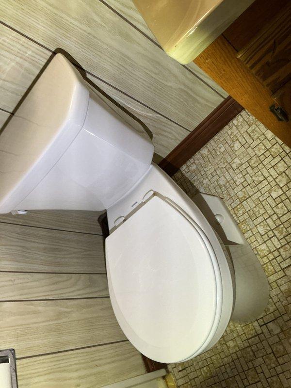 Completed toilet replacement due to rusted floor drain and significant water damage in bathroom. Installed new standard height toilet with wax ring and mounting hardware. Addressed plumbing system issues by replacing deteriorated main gate valves and installing pressure reducing valve (PRV) to correct high water pressure condition.