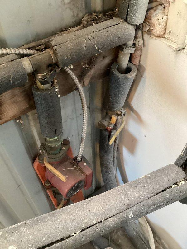 Inspected outdoor wood boiler system at customer's new residence to assess functionality. Met with homeowner to discuss multiple installation projects including wall-mounting the external heat exchanger in basement (requiring connector replacement and new water lines), extending heating to garage living space, running capped water lines to mezzanine level, and relocating well tank inside house. Documented existing plumbing configuration and HVAC components with photos. Scheduled comfort advisor to prepare detailed project estimates for customer approval.