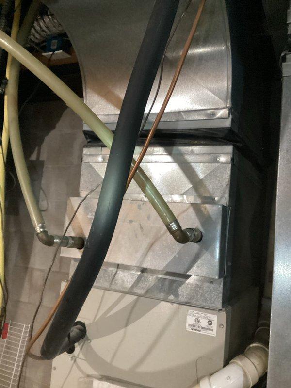 Inspected outdoor wood boiler system at customer's new residence to assess functionality. Met with homeowner to discuss multiple installation projects including wall-mounting the external heat exchanger in basement (requiring connector replacement and new water lines), extending heating to garage living space, running capped water lines to mezzanine level, and relocating well tank inside house. Documented existing plumbing configuration and HVAC components with photos. Scheduled comfort advisor to prepare detailed project estimates for customer approval.