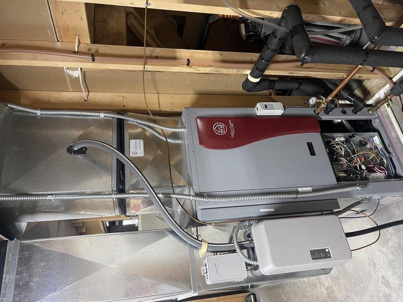 Performed 8-12 geothermal system tune-up under Rewards membership. Found system low on water, added water for in-floor heat system, and verified proper operation with normal pressure and temperature readings. Discussed supplemental heating options with homeowner Roy, who requested an estimate for a new gas furnace to be installed alongside the geothermal unit.