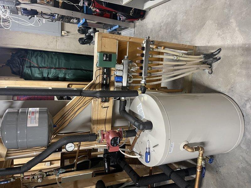 Performed 8-12 geothermal system tune-up under Rewards membership. Found system low on water, added water for in-floor heat system, and verified proper operation with normal pressure and temperature readings. Discussed supplemental heating options with homeowner Roy, who requested an estimate for a new gas furnace to be installed alongside the geothermal unit.