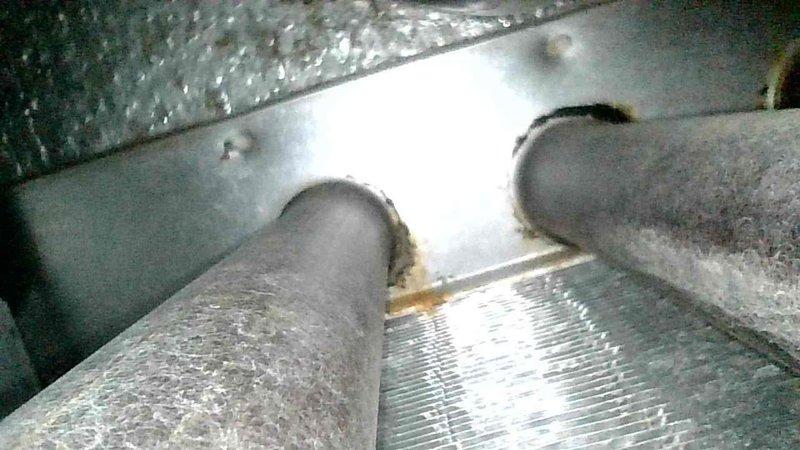 Responded to no heat call for 20-year-old furnace. Diagnosed control board failure preventing inducer motor startup. Further inspection revealed severely compromised heat exchanger with significant corrosion, visible holes and cracks in the back header. Documented damage with photos, tagged system as unsafe for operation, and scheduled follow-up consultation with customer.